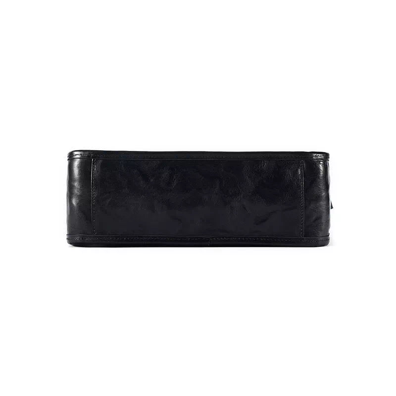 Fashion-forward black leather crossbody bag with vegetable-tanned texture