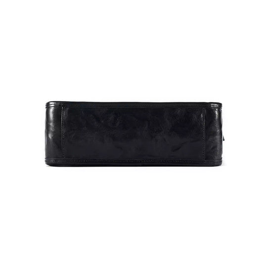 Fashion-forward black leather crossbody bag with vegetable-tanned texture