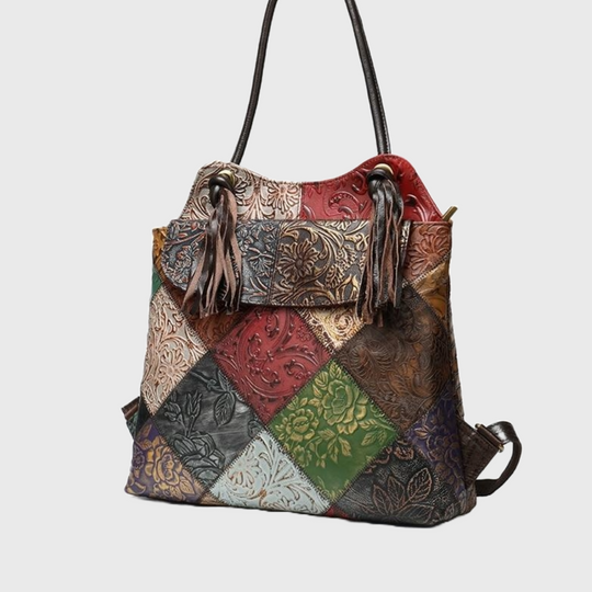 Lady's sling bag or backpack with floral embossed designs on leather patchwork