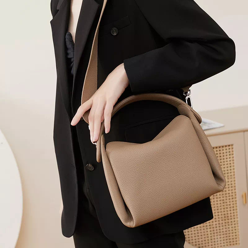 Chic crossbody bag featuring classic design and top handle