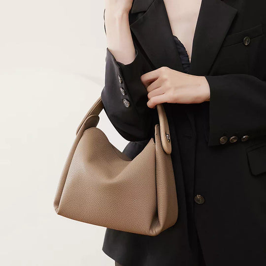 Elegant leather crossbody bag with a classic touch and top handle