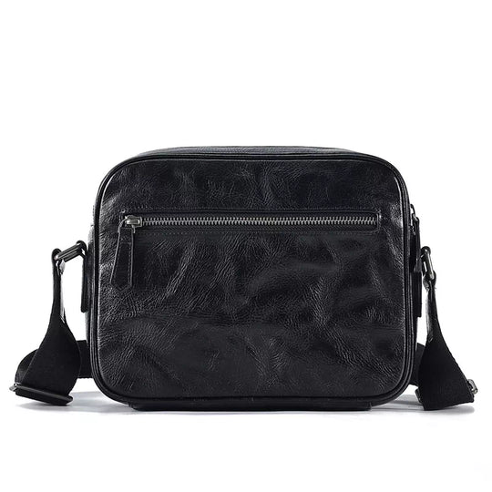 Black vegetable-tanned leather crossbody bag in a compact size