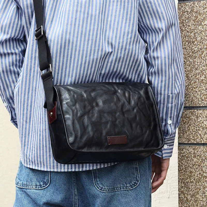 Modern black leather crossbody bag with vegetable-tanned finish